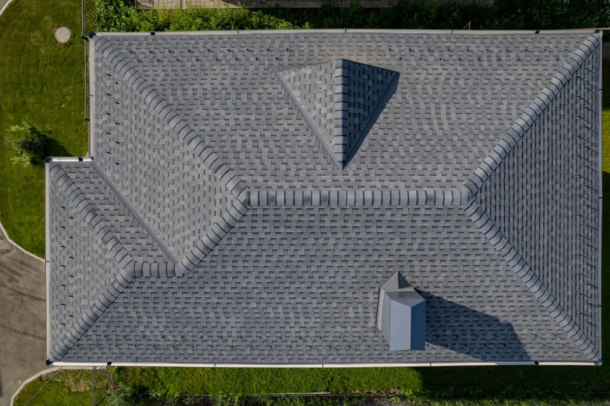 Aerial view of a Minneapolis roof showing gutter and downspout layout — sizing and placement determine drainage capacity